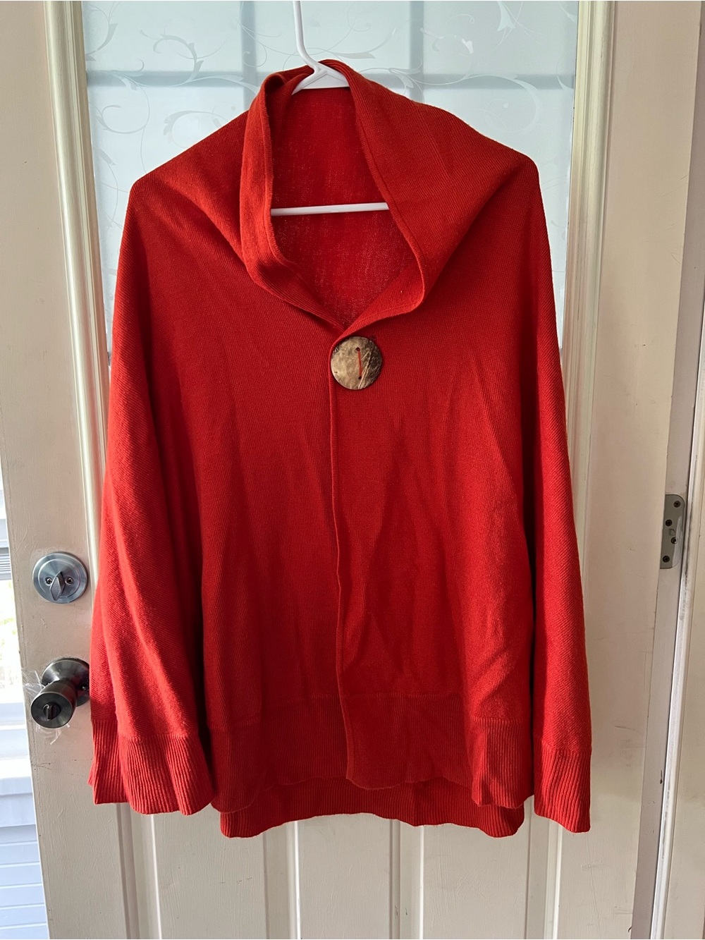 Katie Todd orange knit one button cape/poncho, with draped collar.